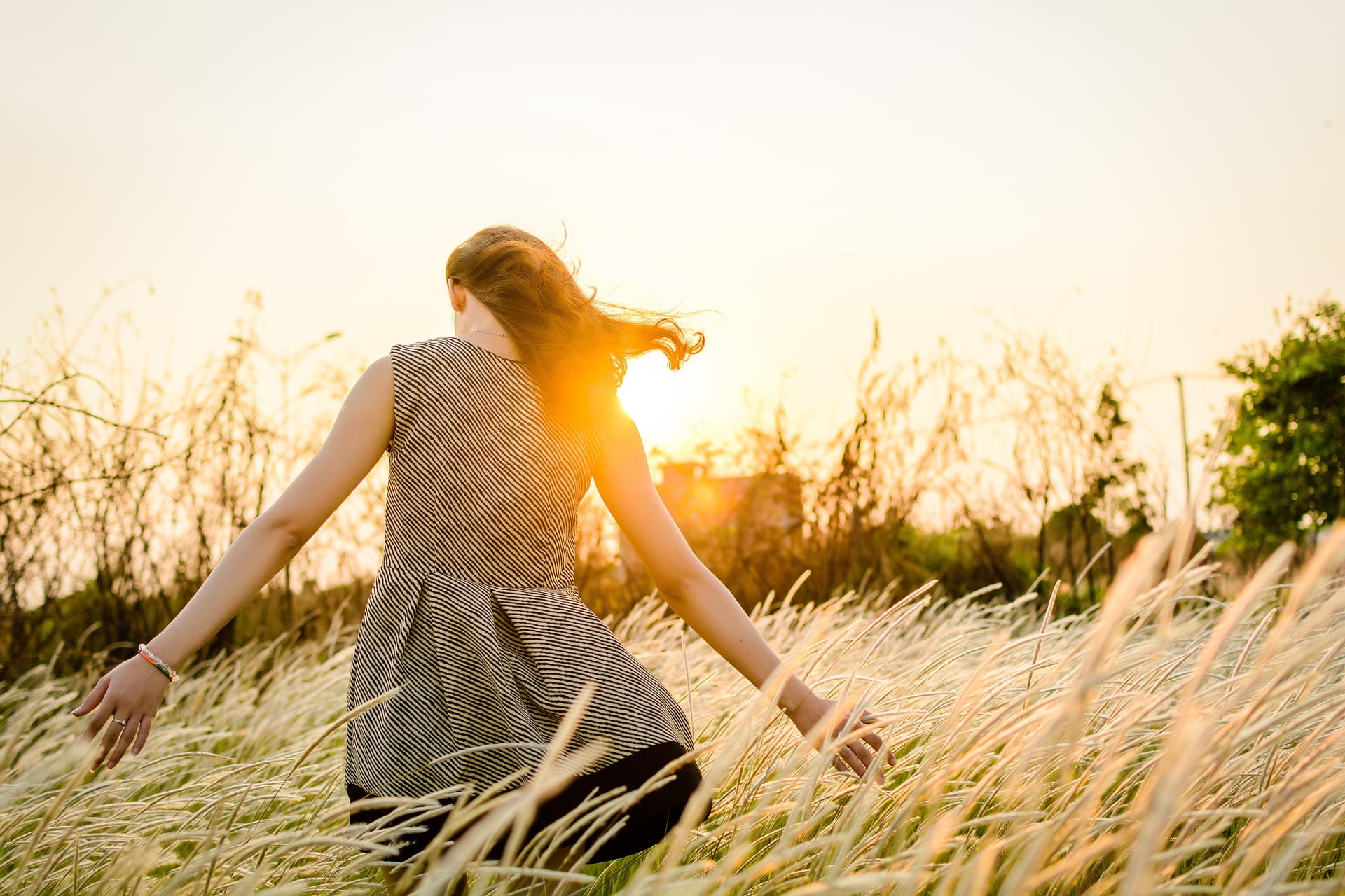 woman stands in sun